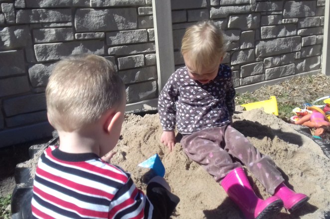 two kids in a sand box